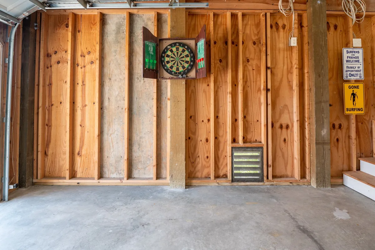 A cozy nook with wood-paneled walls, a classic dartboard, and quirky signage, set up for friendly games and group laughter.